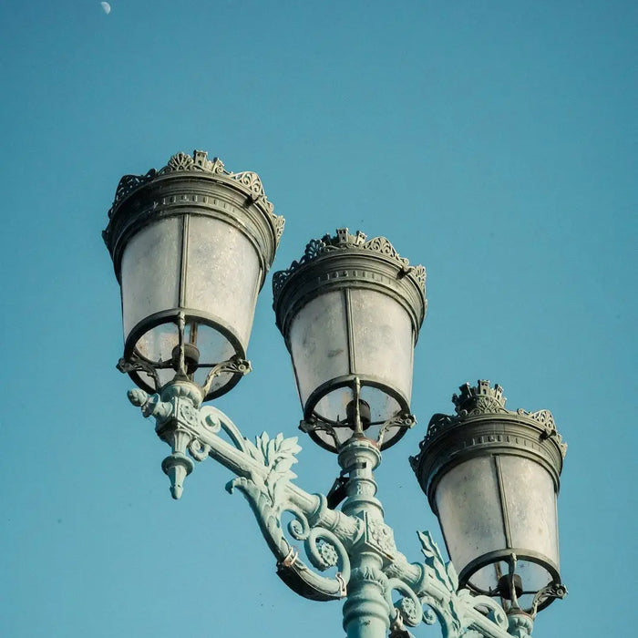 Ornate street lamp with three globular lights enhancing creative picture frames ambiance