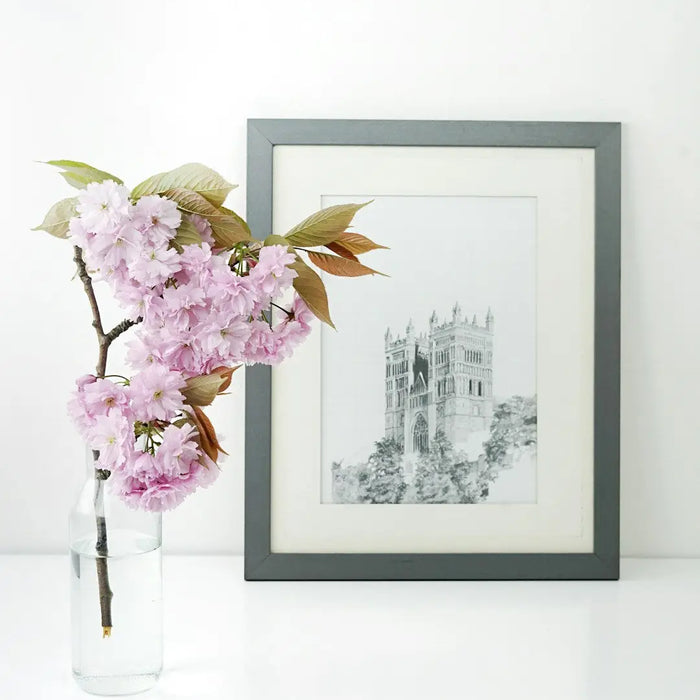 Framed cathedral sketch with pink cherry blossoms in modern memory design decor.