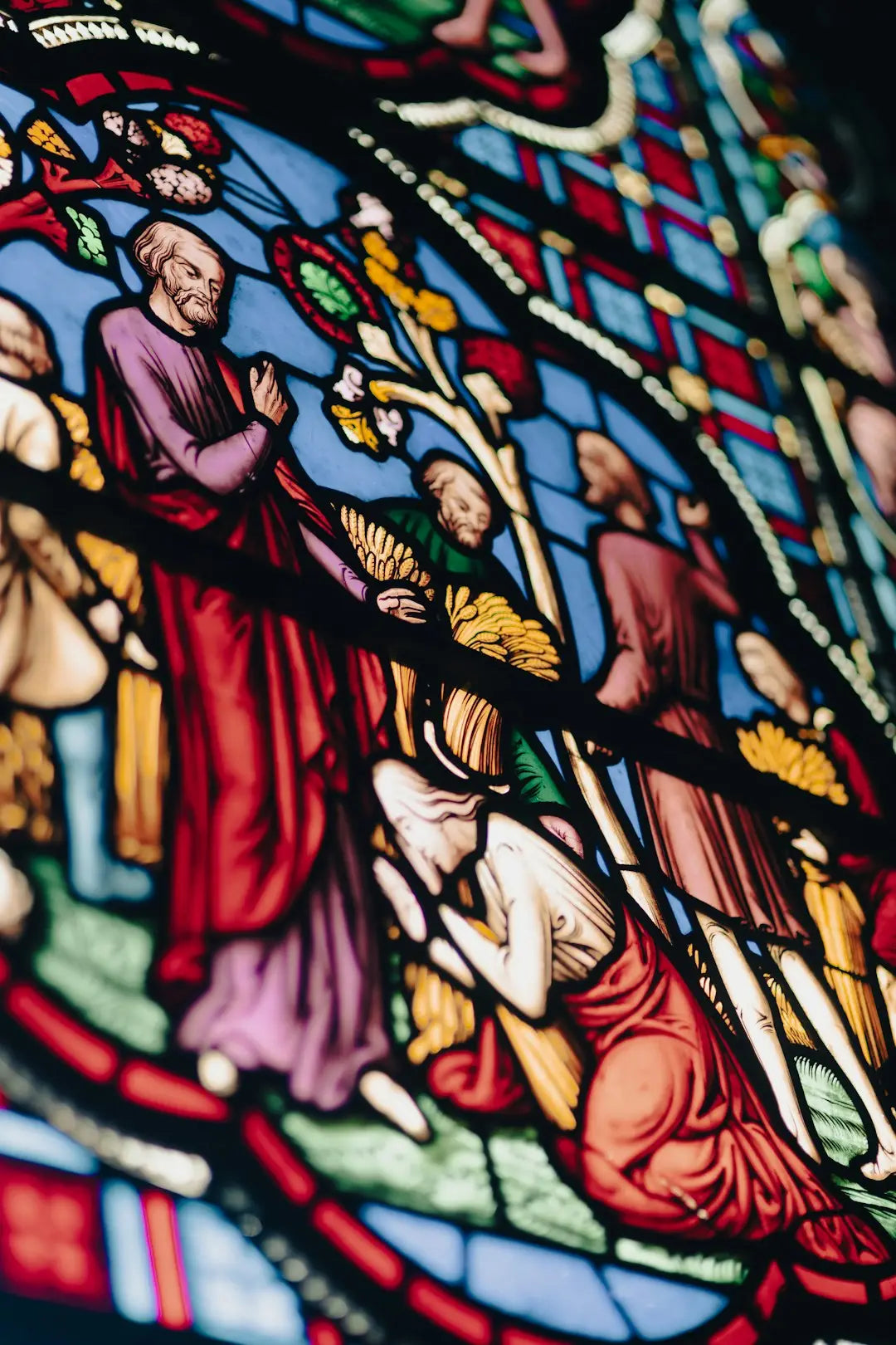 Stained glass window with religious figures enhances custom framing for modern memory.