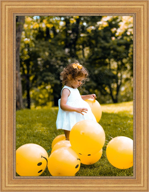 Young child in a white dress with yellow balloons in a 36x48 picture frame